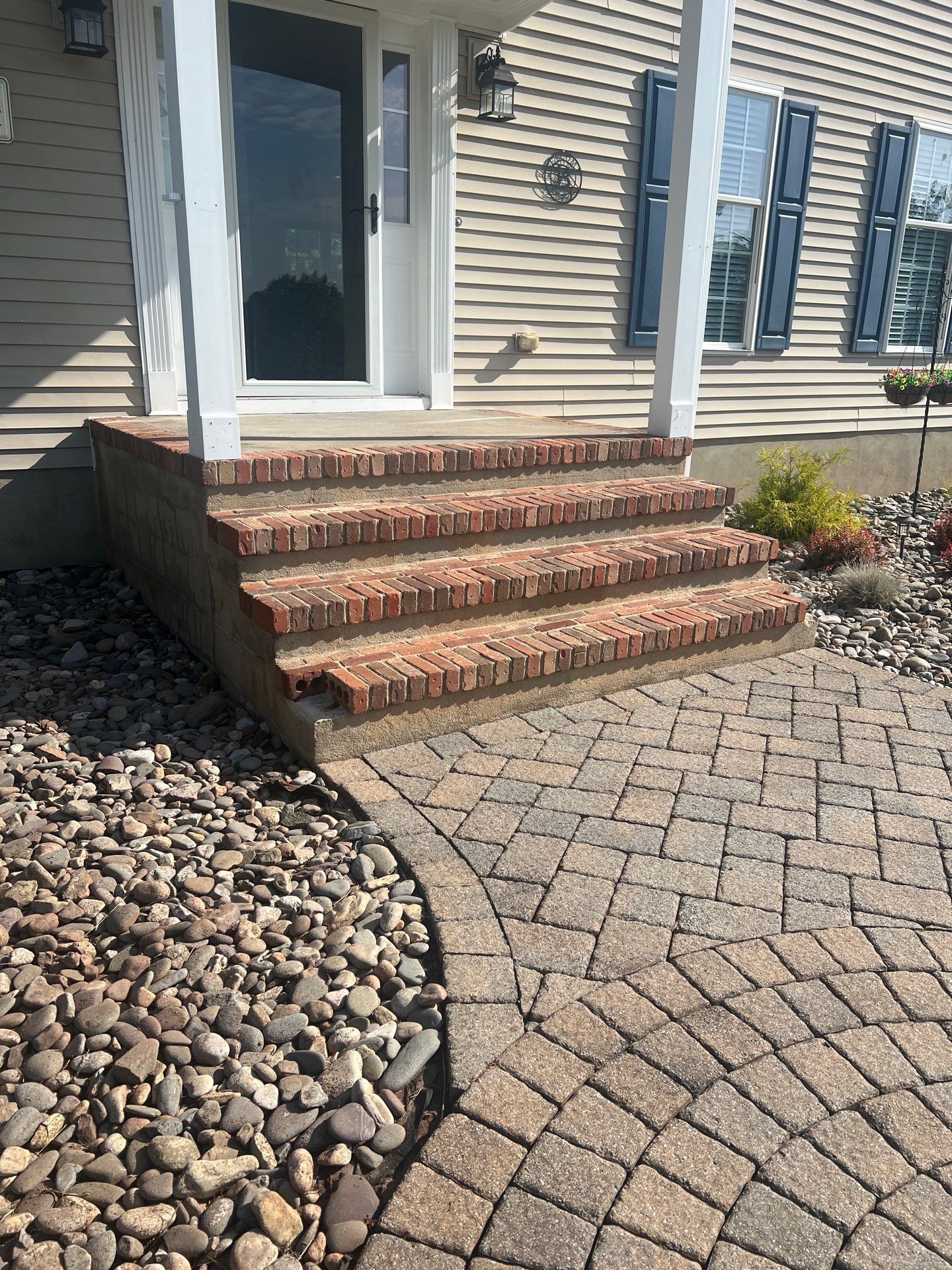 Brick steps with decorative stone and mulch by Hill Landscaping in Clinton Township